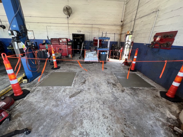 Two finished lift footings in a shop, marked off with cones.