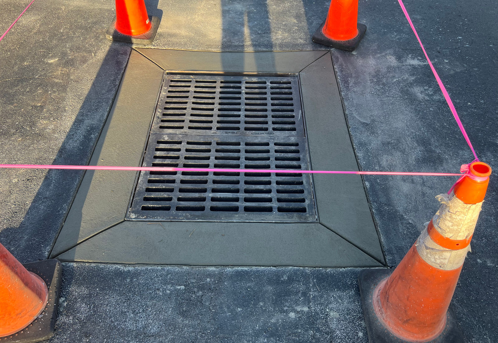 Drain inlet grate reset in the street after the frame was replaced.