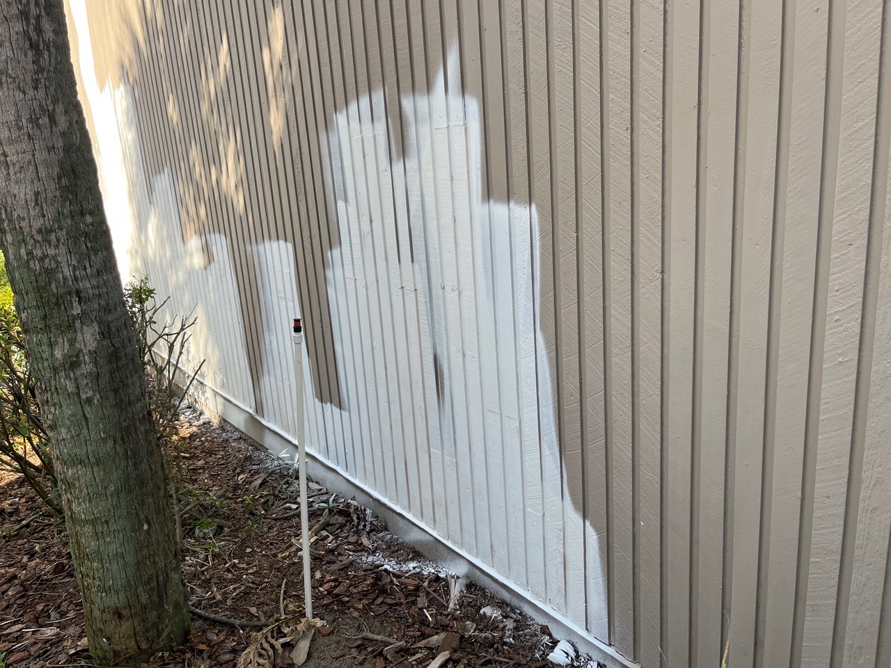 Primer applied to a grooved exterior wall before a finish coat.