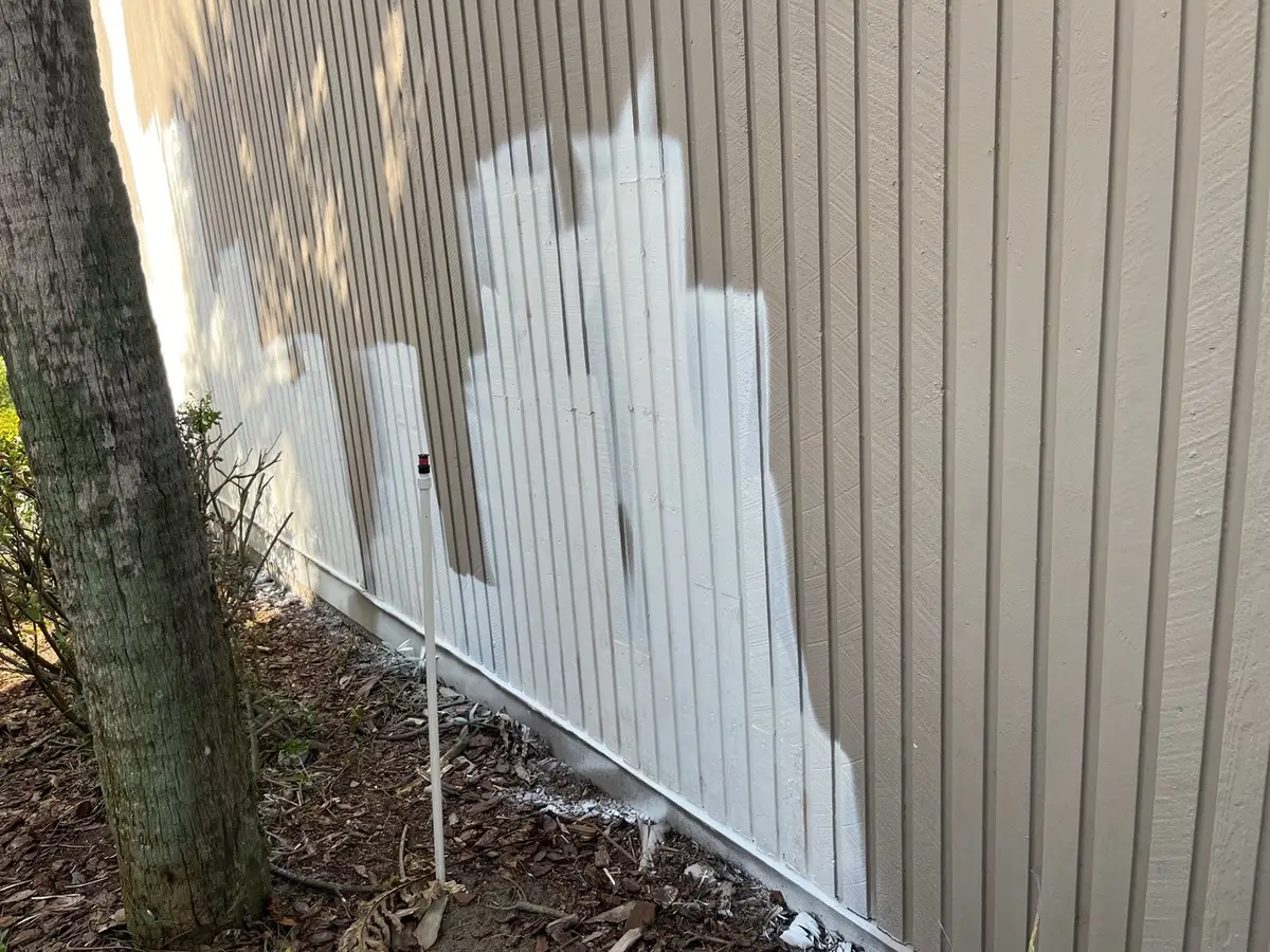 Primer applied to a grooved exterior wall before a finish coat.